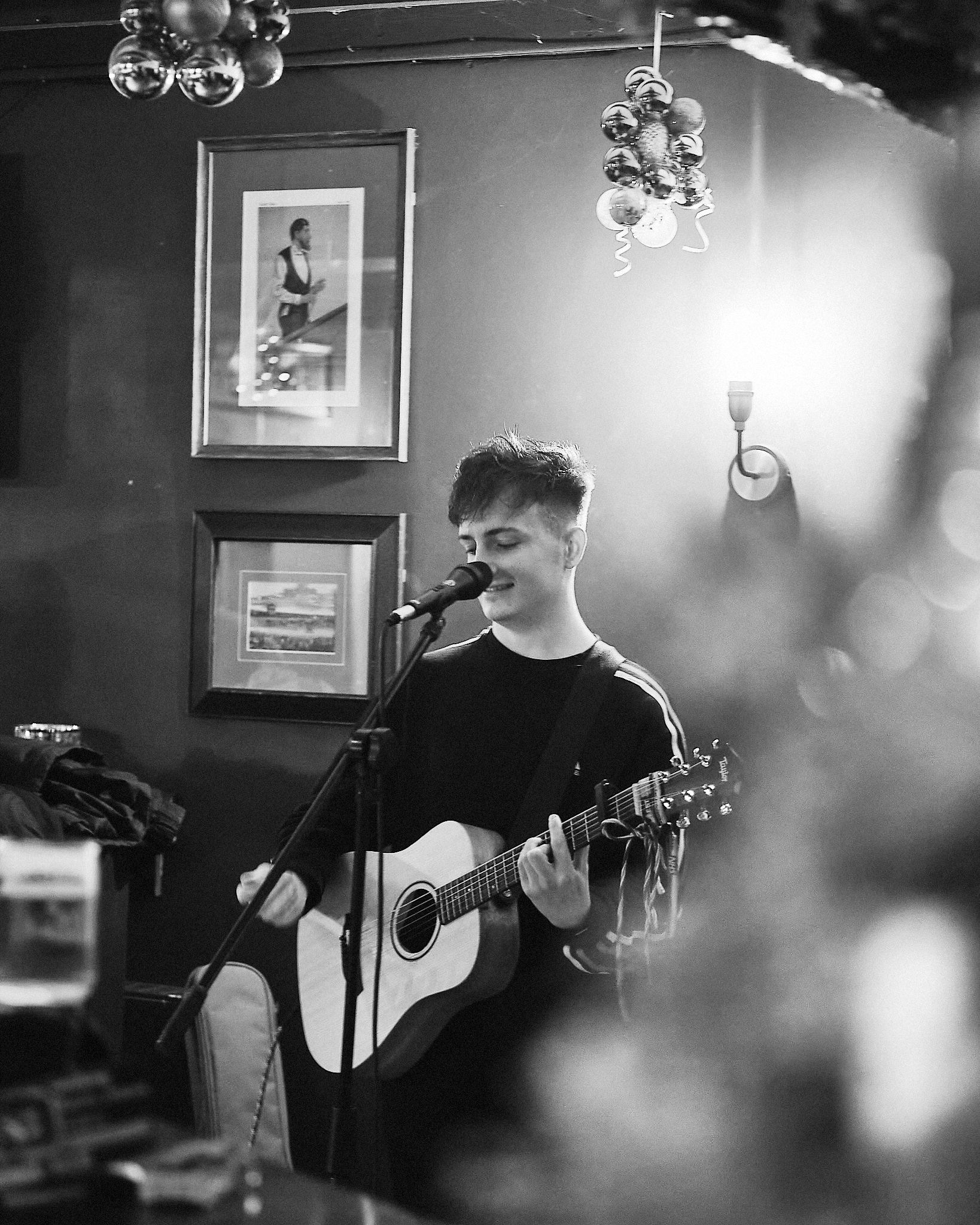 Michael Plumb performing acoustic music in black and white