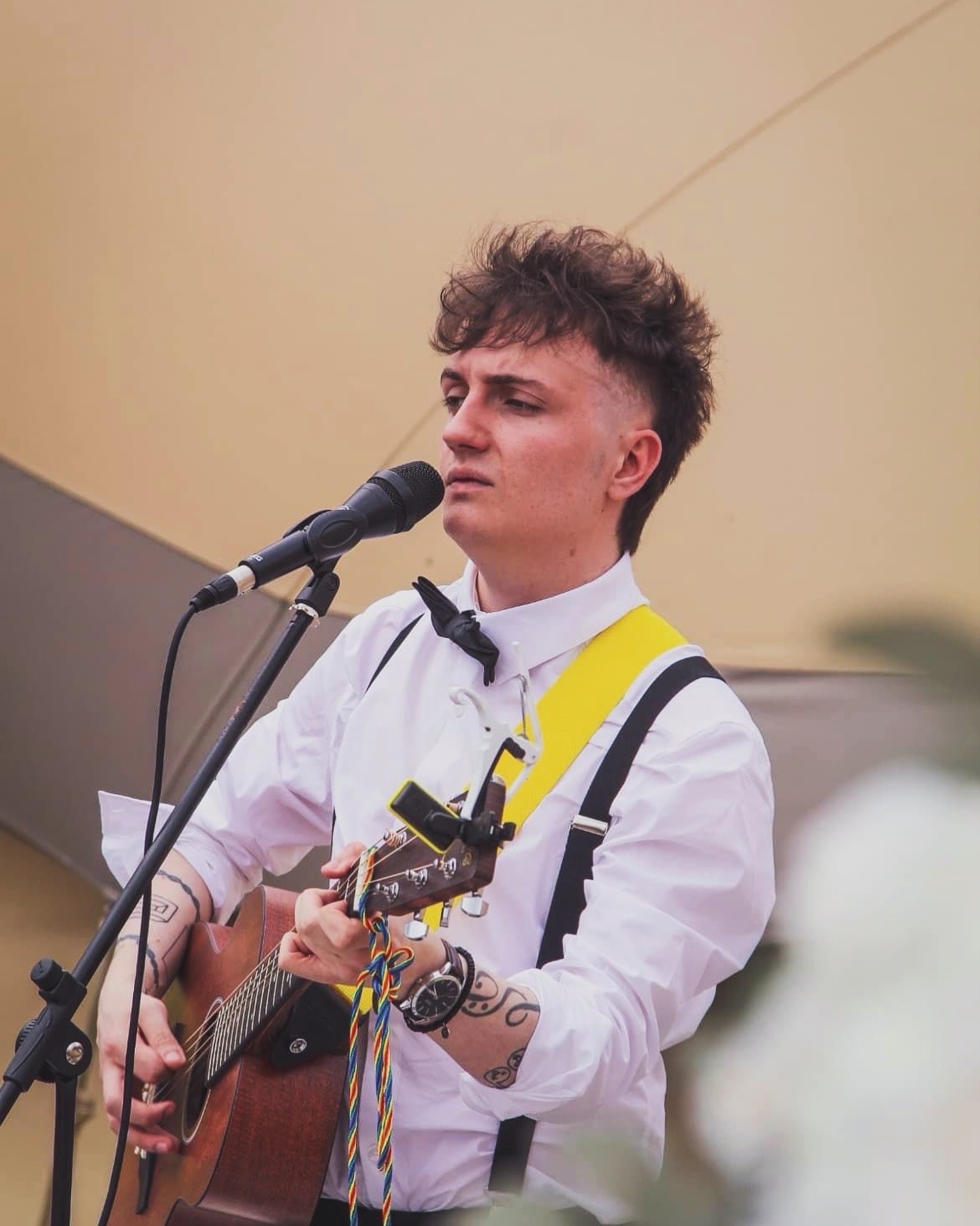 Michael Plumb singing and playing acoustic guitar